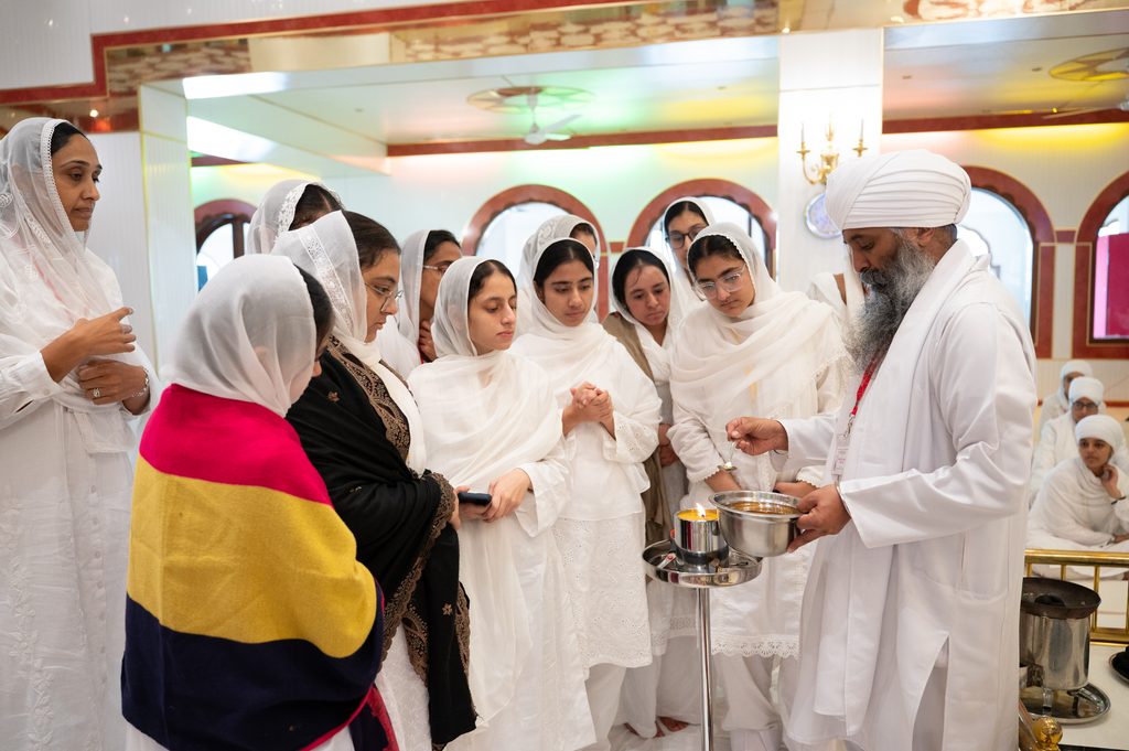 Students witnessing ghee being added to a joht